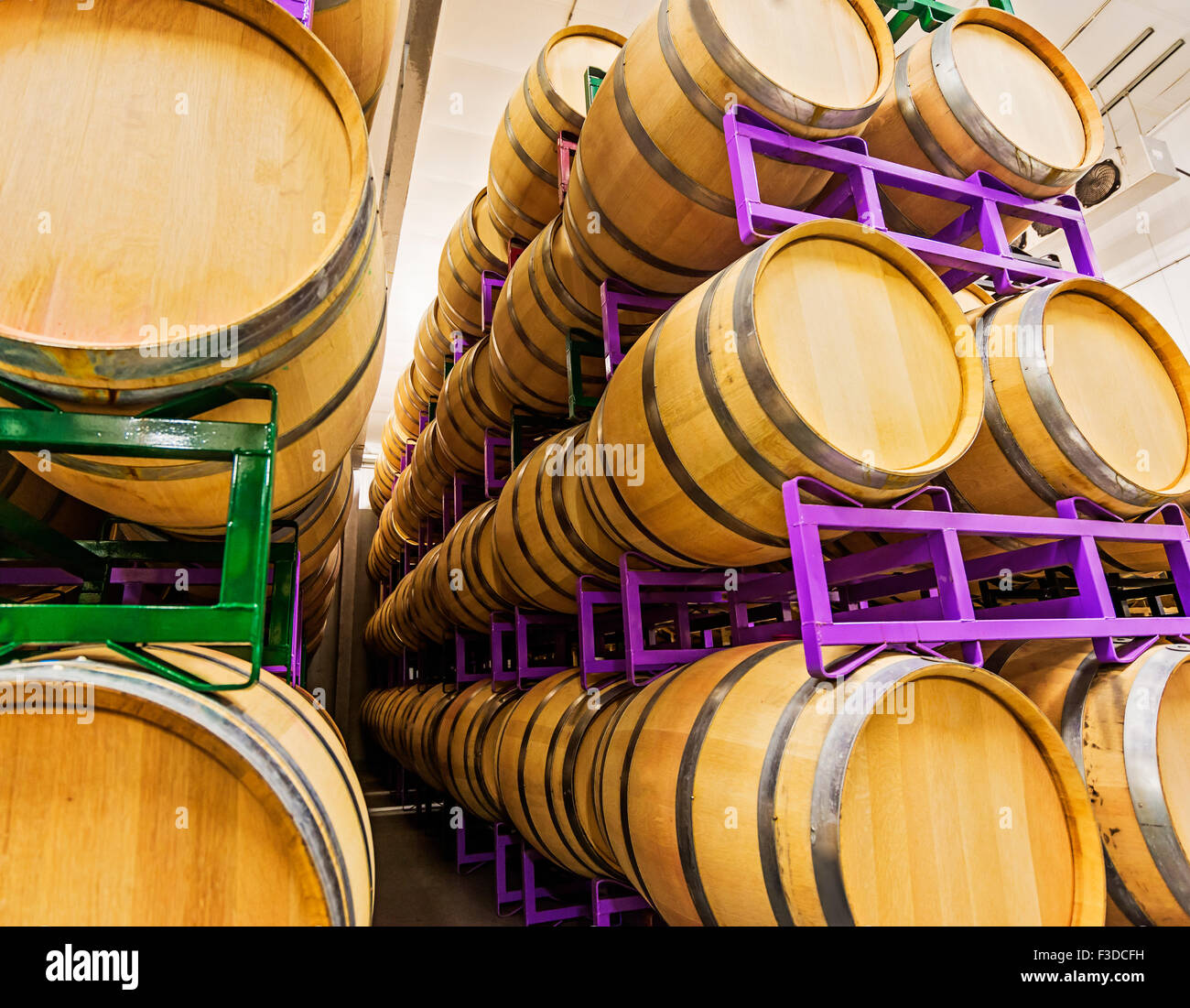 Wine barrels on racks in cellar Stock Photo