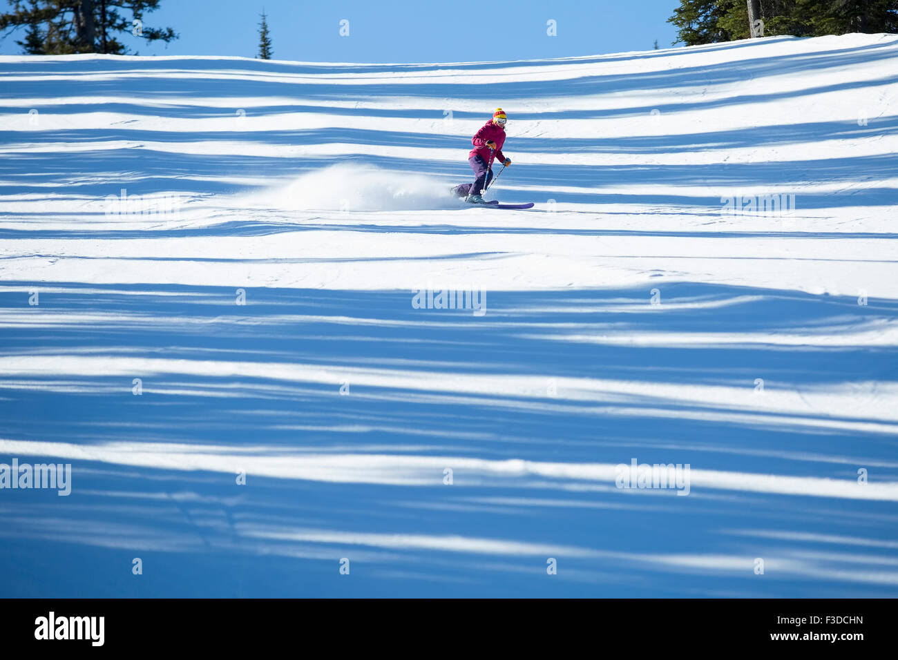 Woman skiing downhill Stock Photo