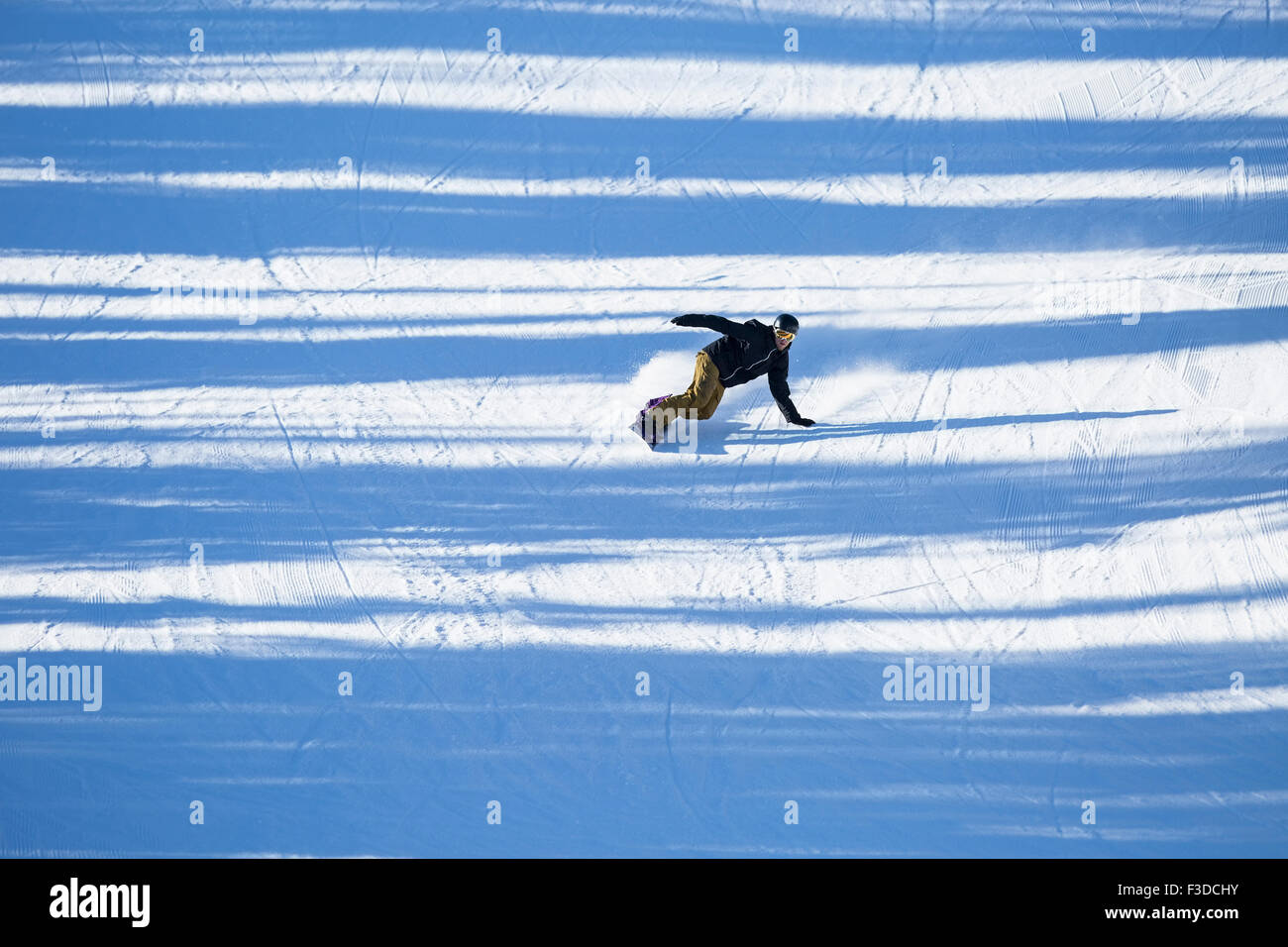 Man snowboarding downhill Stock Photo