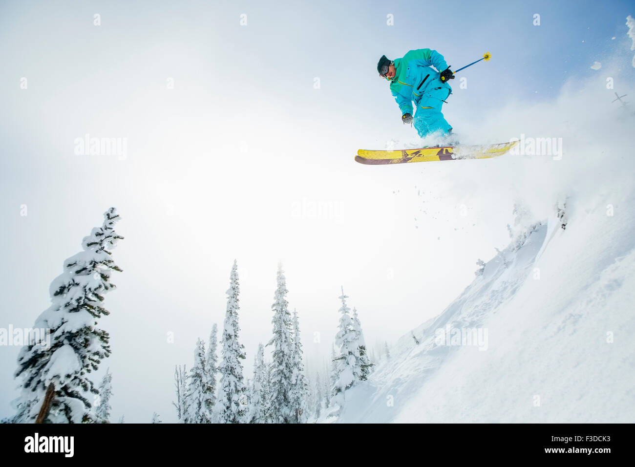 Young man jumping from ski slope Stock Photo