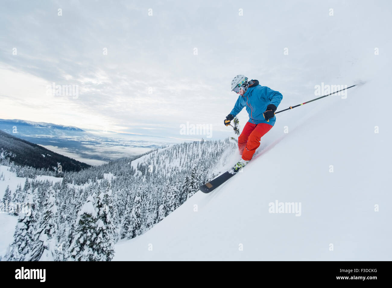 Mature man speeding on ski slope Stock Photo