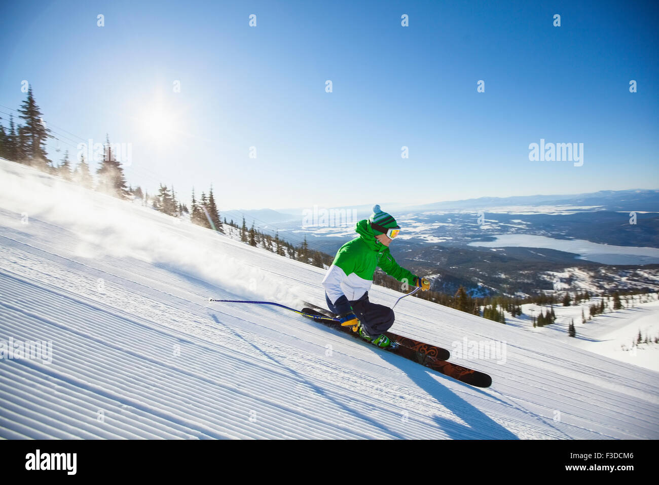 Mature man on ski slope at sunlight Stock Photo
