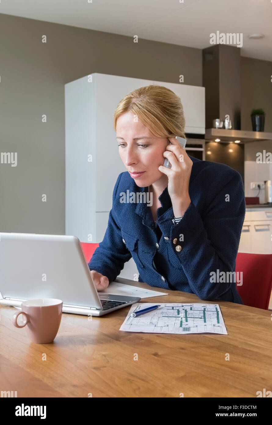 Woman working at desk Stock Photo - Alamy