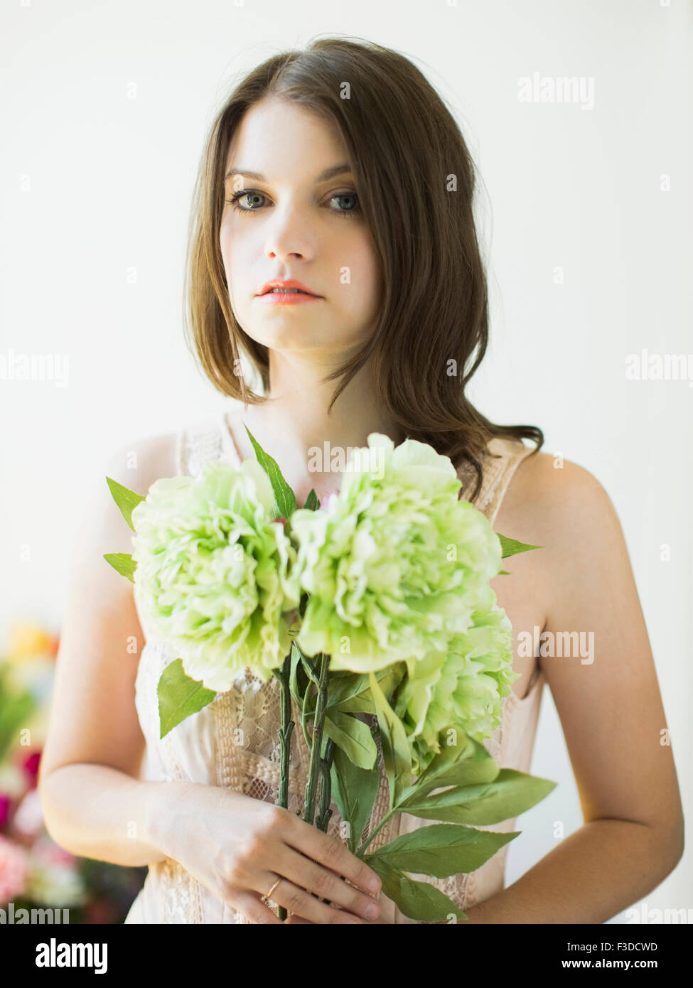 Portrait of woman holding flowers Stock