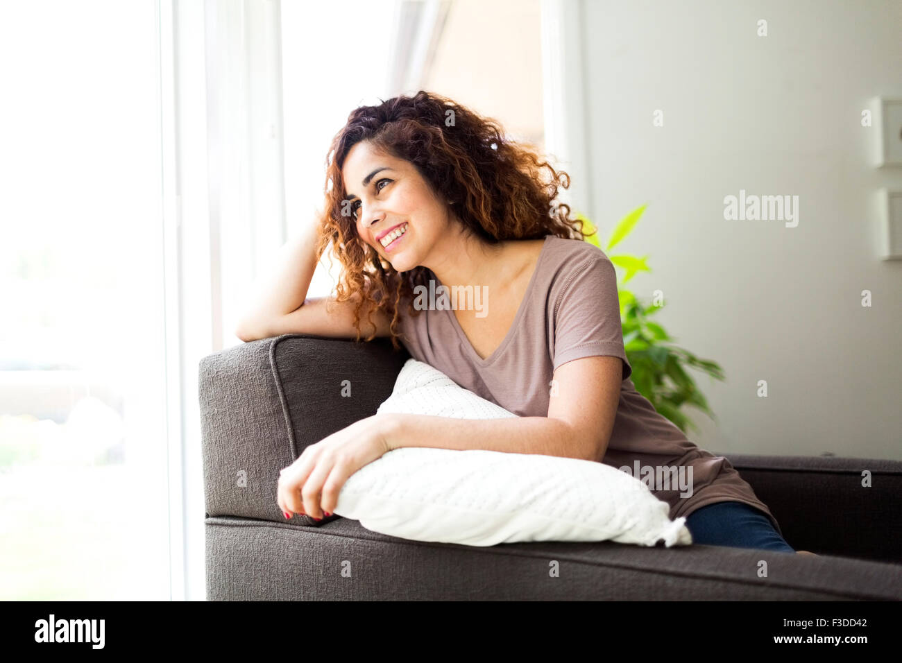 Woman relaxing sofa hi-res stock photography and images - Alamy
