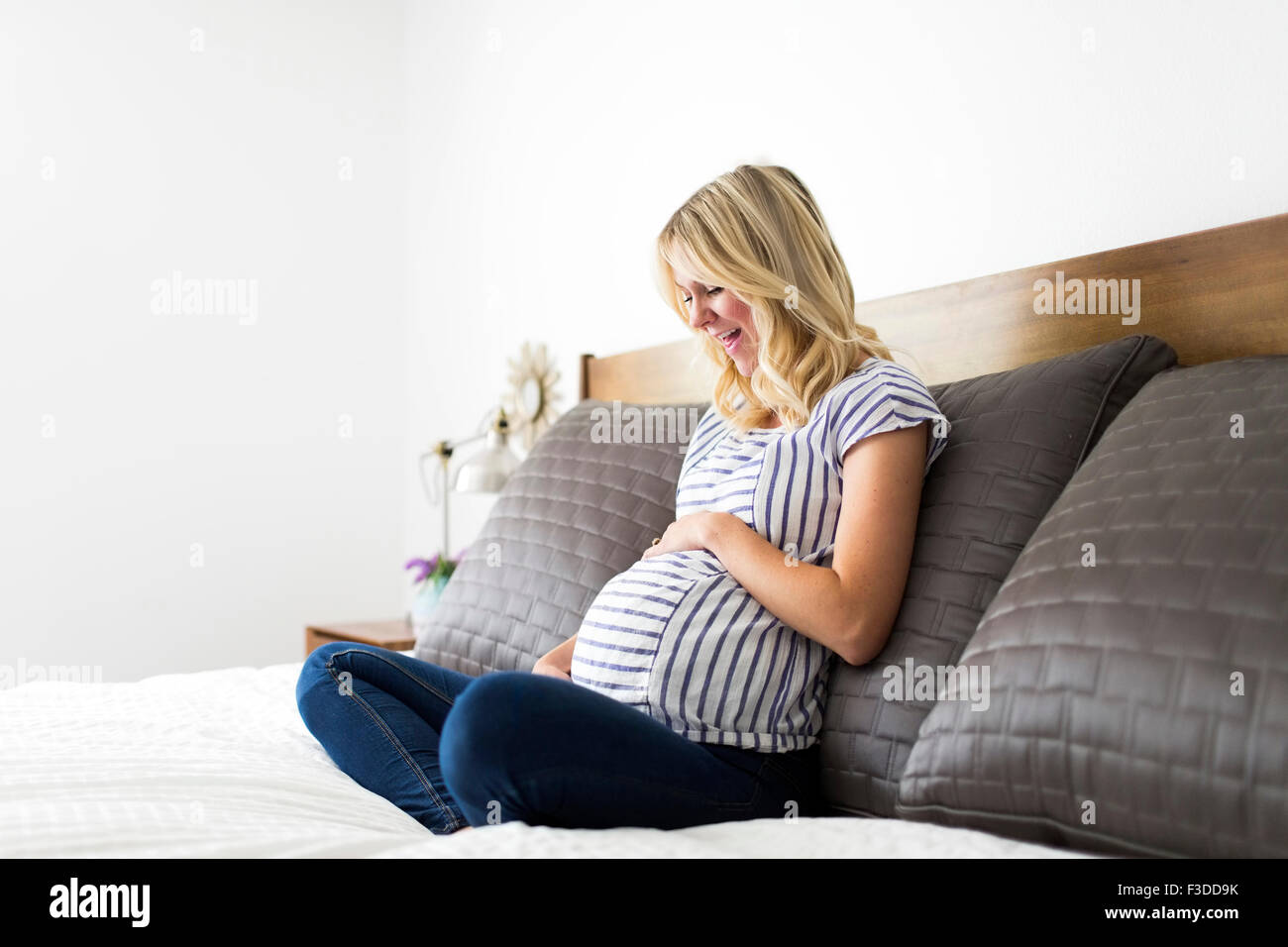Portrait of pregnant woman touching belly Stock Photo