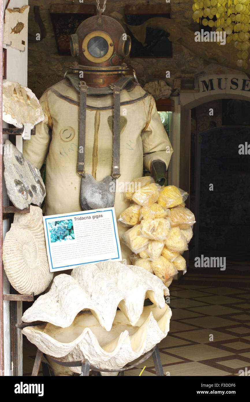 Vieste, Italy - September 16, 2015: Entrance to the museum of shells. Antique diver's suit and large seashells. Stock Photo