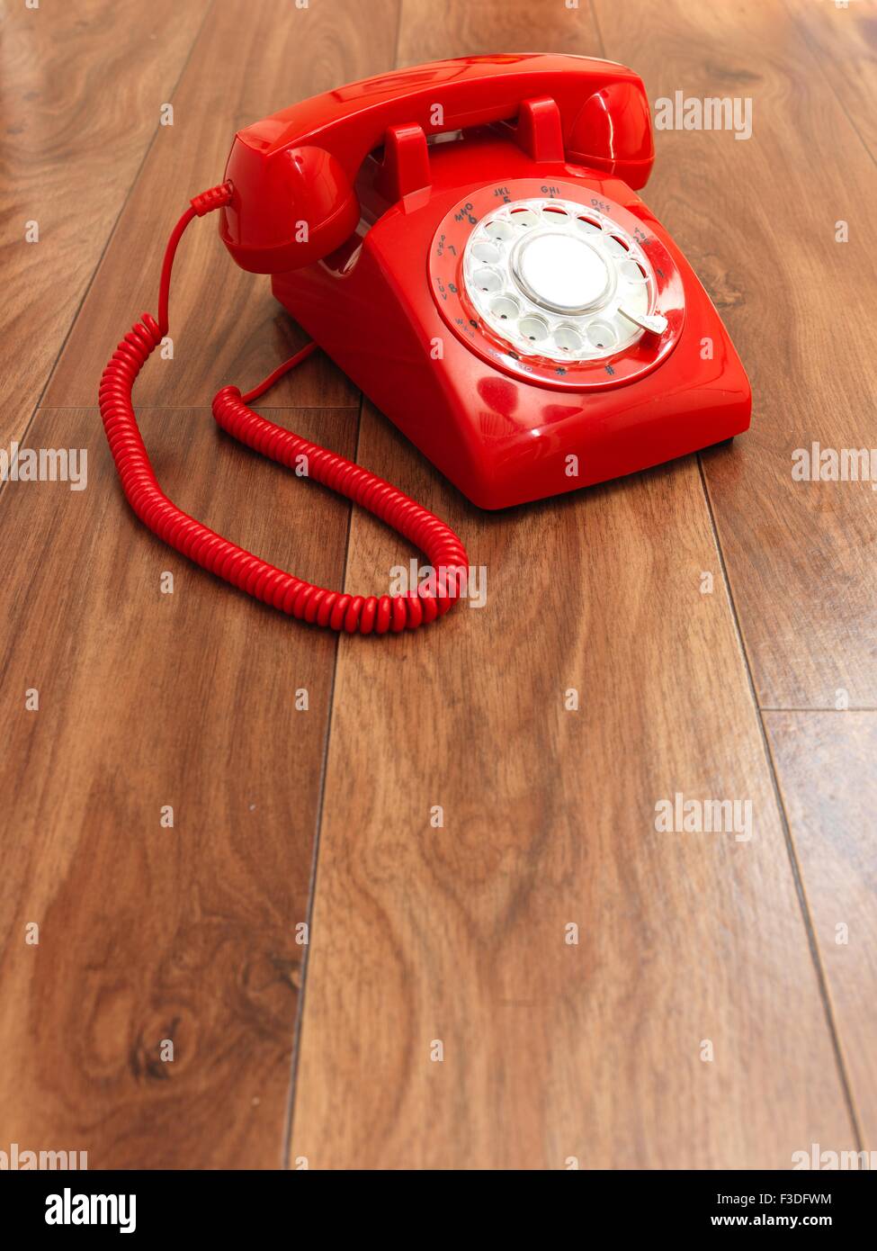 A close up photo of a red rotary phone Stock Photo