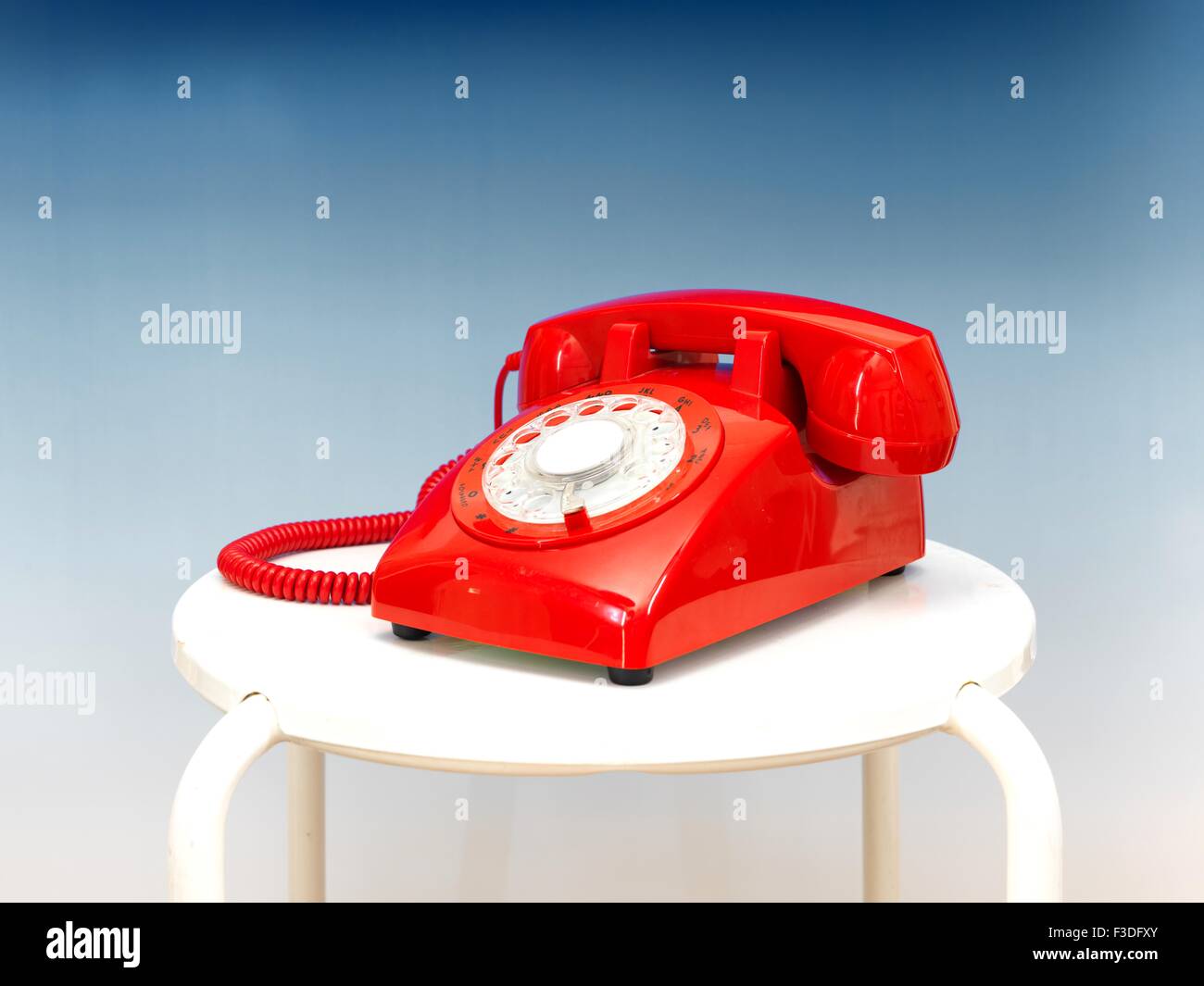 A close up photo of a red rotary phone Stock Photo