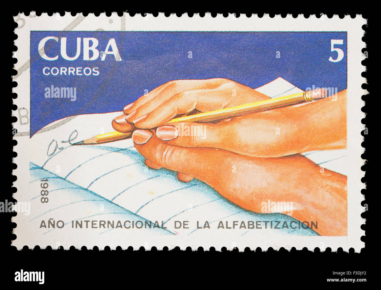 CUBA - CIRCA 1988: A postage stamp printed in Cuba shows a hand helping someone else to write, International Literacy year, circ Stock Photo