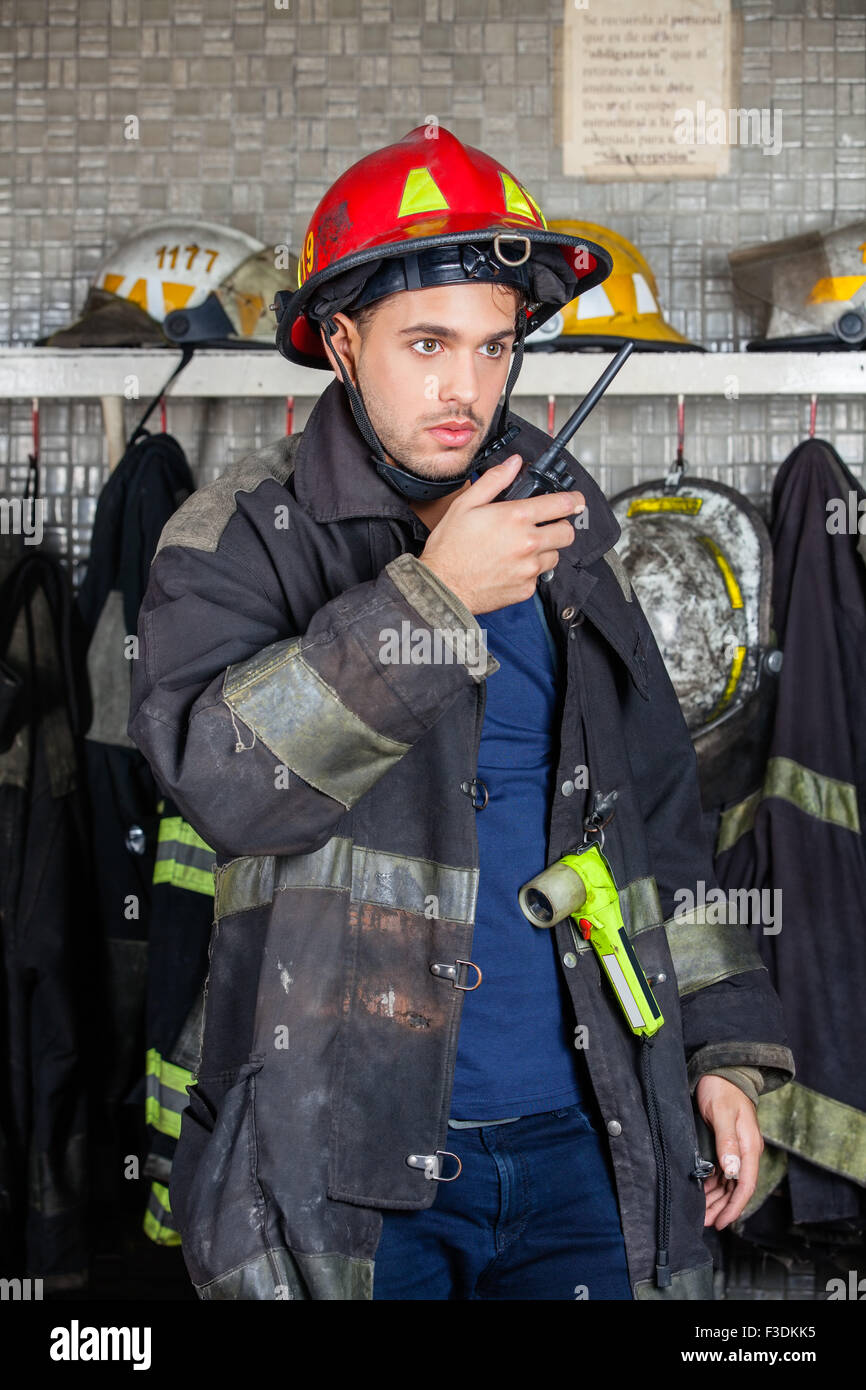 Firefighter Using Walkie Talkie At Fire Station Stock Photo - Alamy