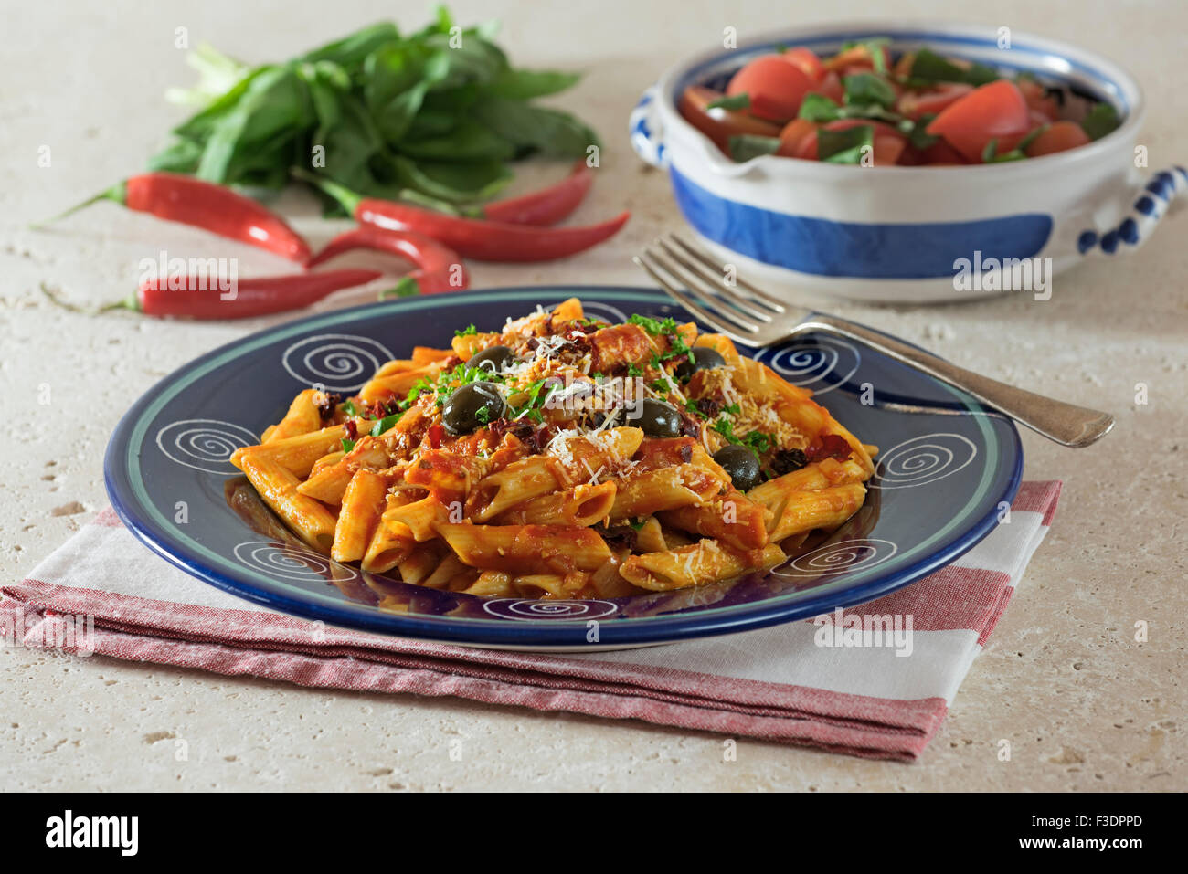 Penne all'Arrabbiata. Pasta in spicy tomato sauce. Italy Food Stock Photo