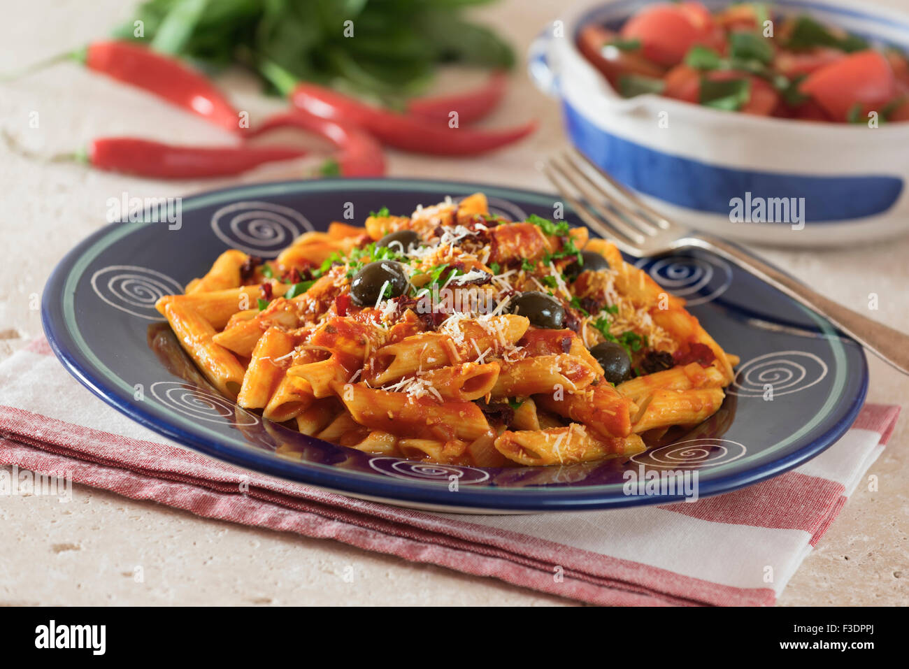 Penne all'Arrabbiata. Pasta in spicy tomato sauce. Italy Food Stock Photo