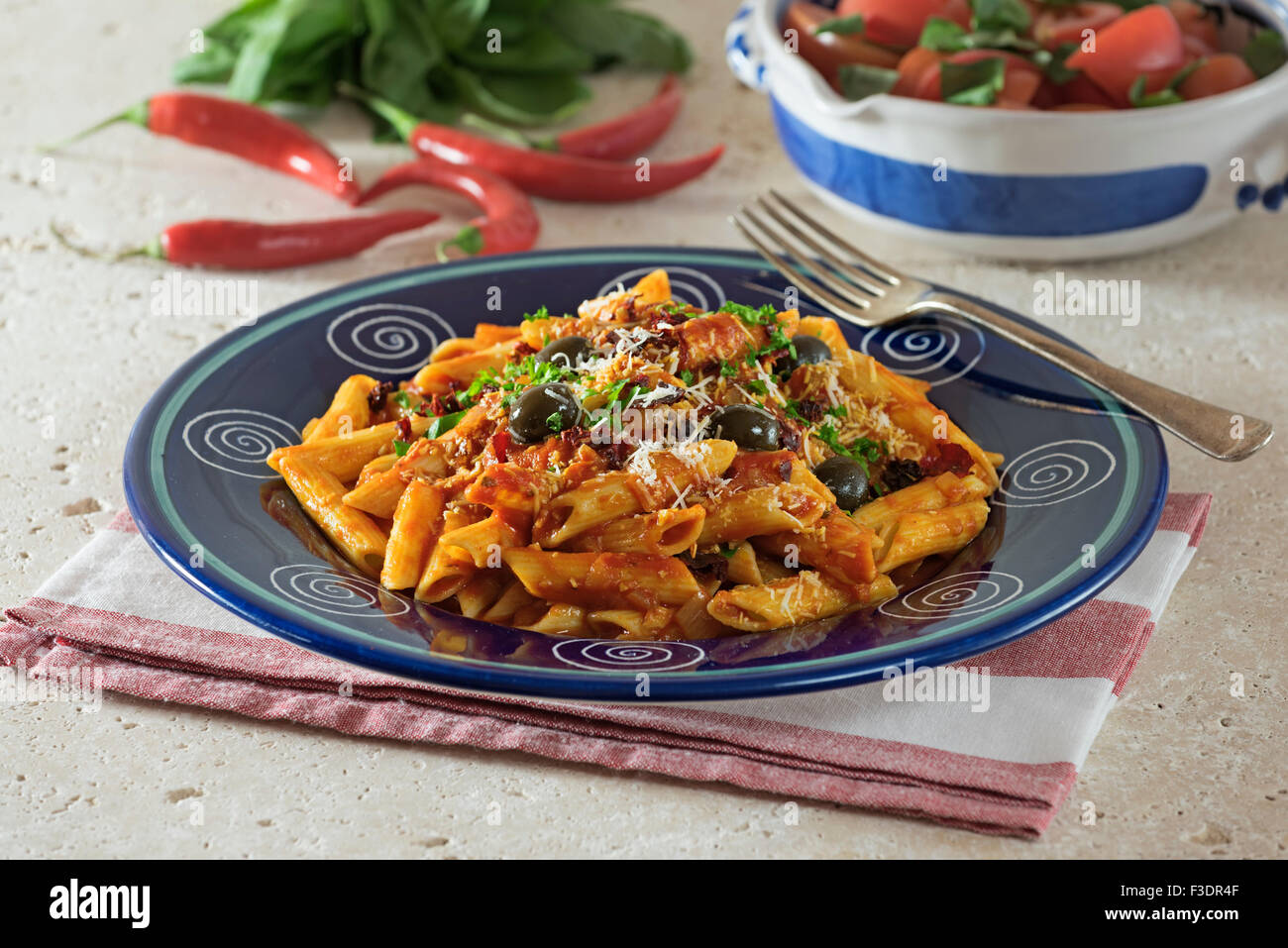 Penne all'Arrabbiata. Pasta in spicy tomato sauce. Italy Food Stock Photo