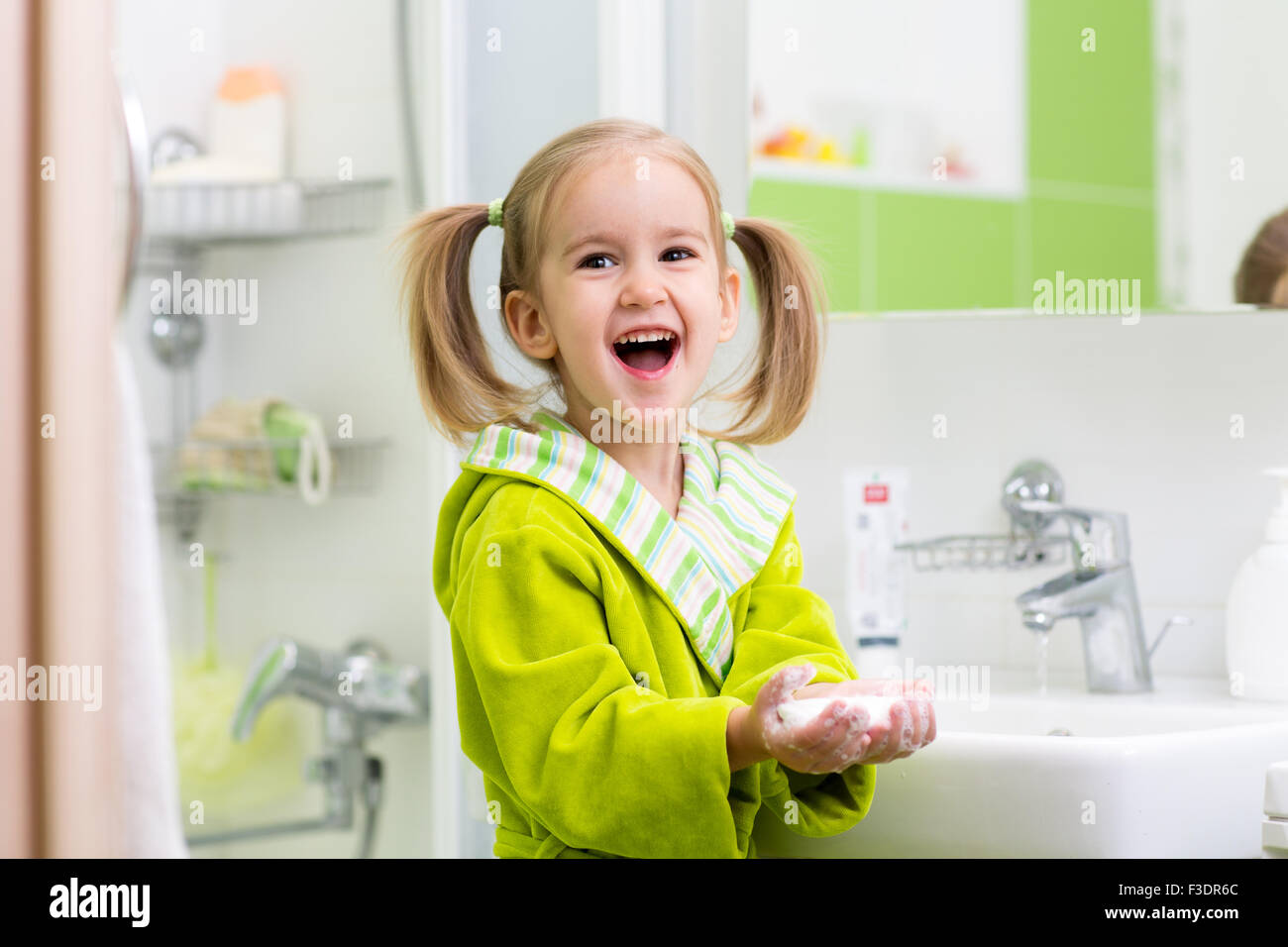 Little girl washing her hands in bathroom Stock Photo - Alamy