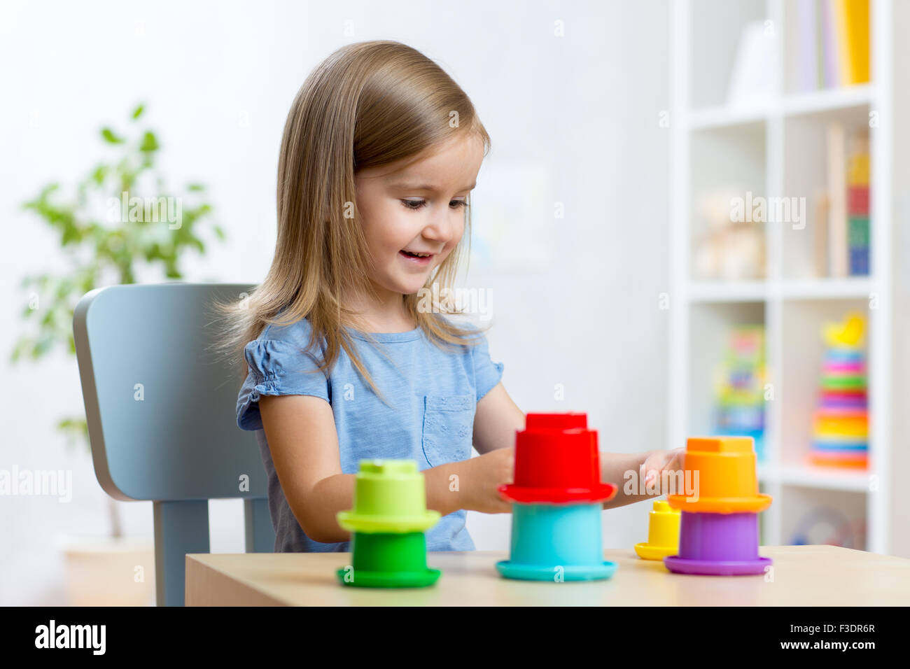 kid little girl playing with toys indoors Stock Photo