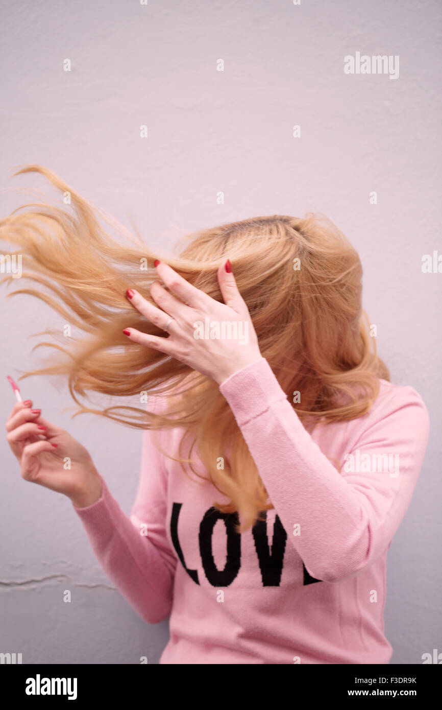 Young romantic themed woman in urban area Stock Photo