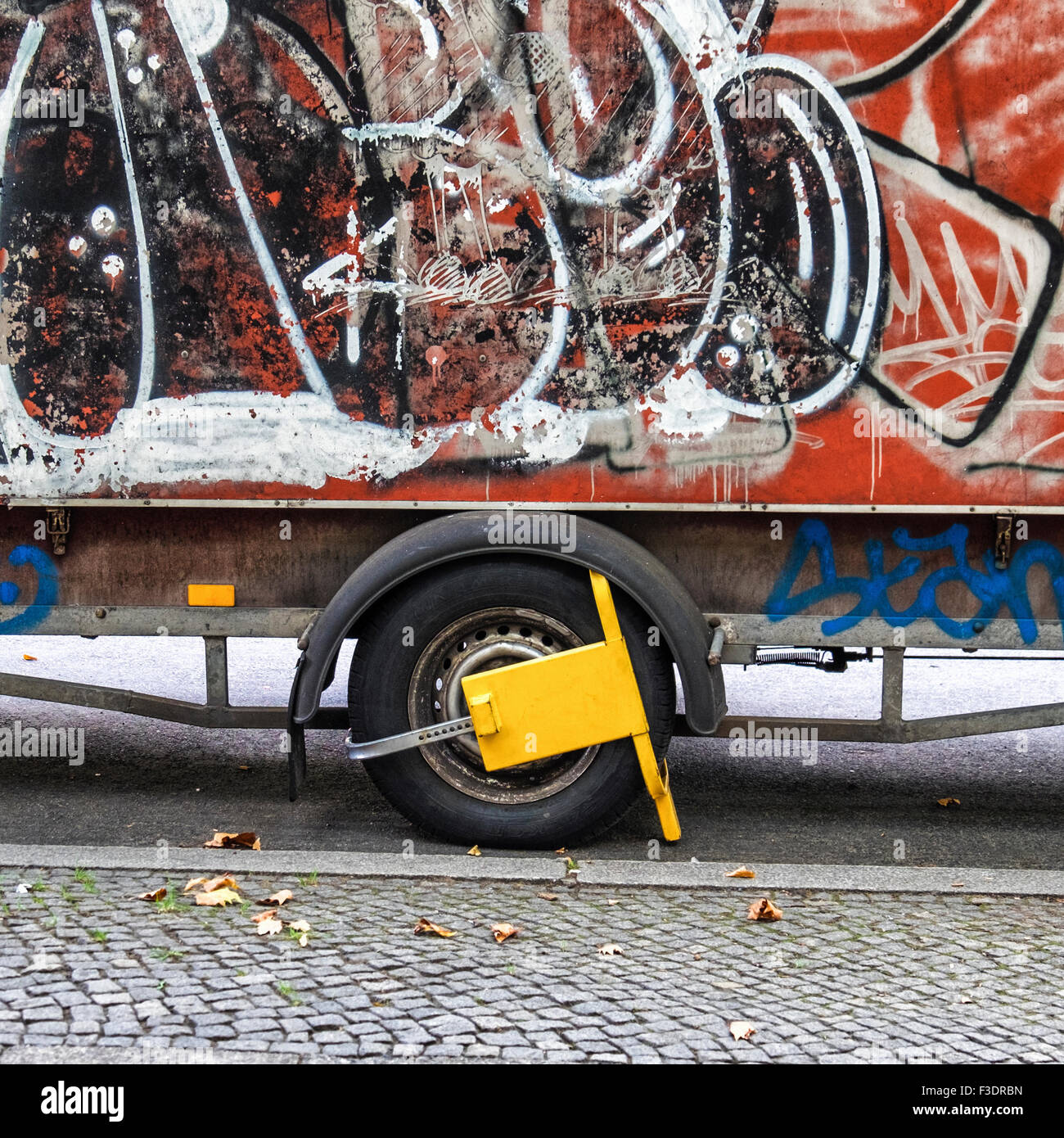 Wheel Clamp on Graffiti covered trailer Stock Photo Alamy