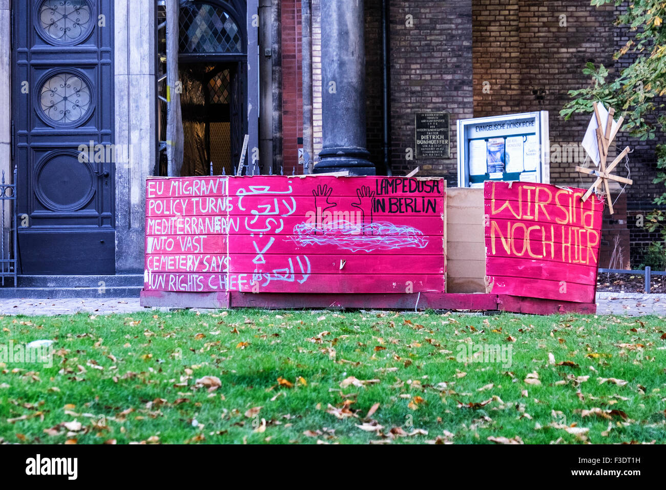 Berlin Zionskirche, Evangelical Zion church with protest art, Boat protesting death of refugees in the Mediterranean sea. Stock Photo