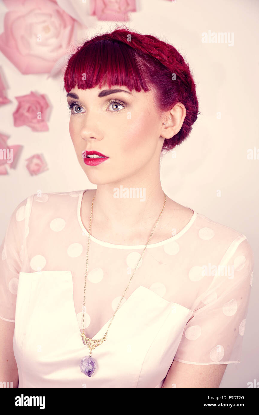 Beautifully romantic red haired girl in a contemporary studio setting Stock Photo