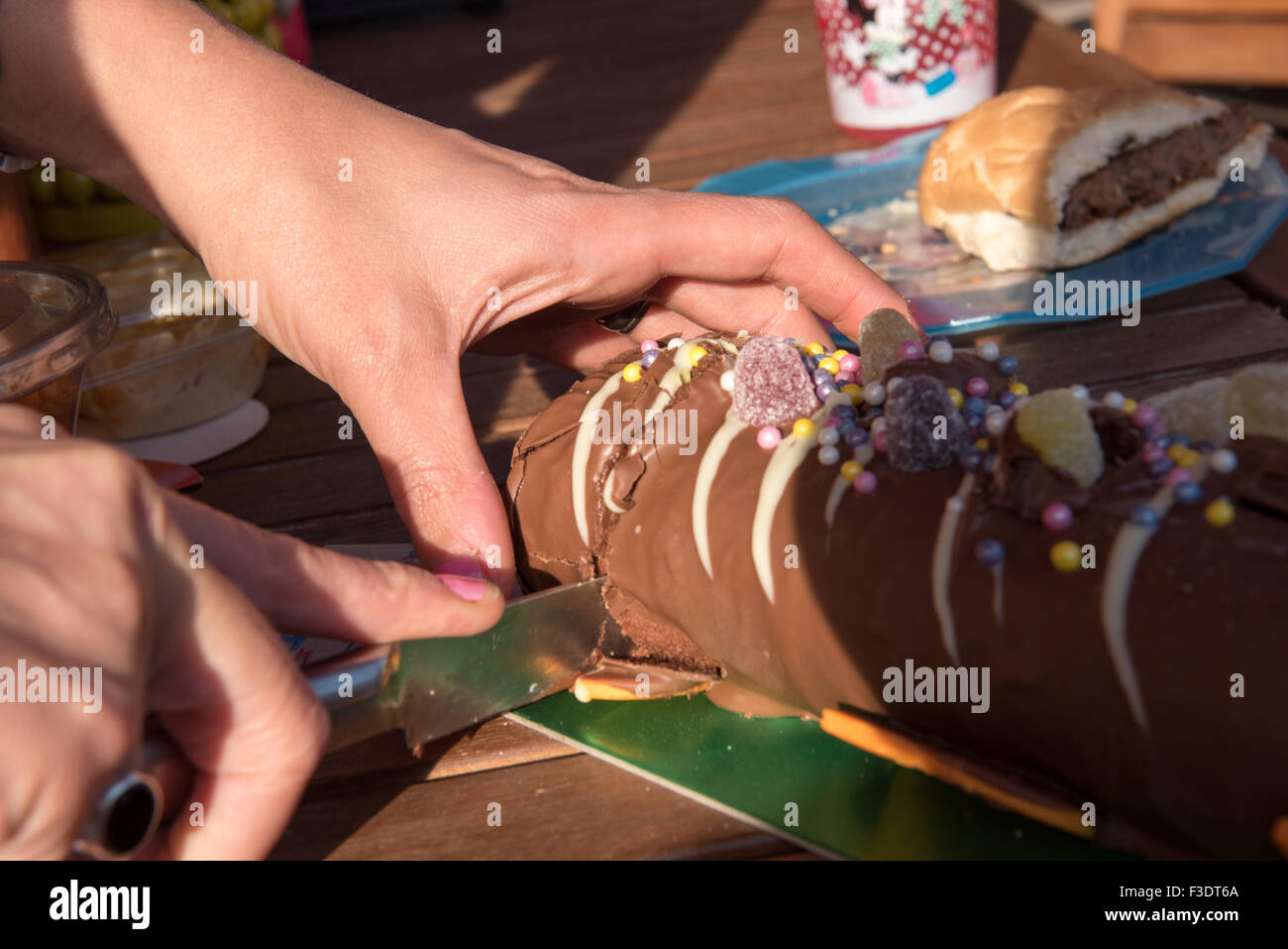 Close up of cake being cut at BBQ Stock Photo