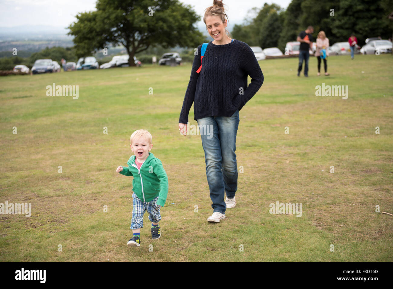 Mother happily walking with playful son Stock Photo