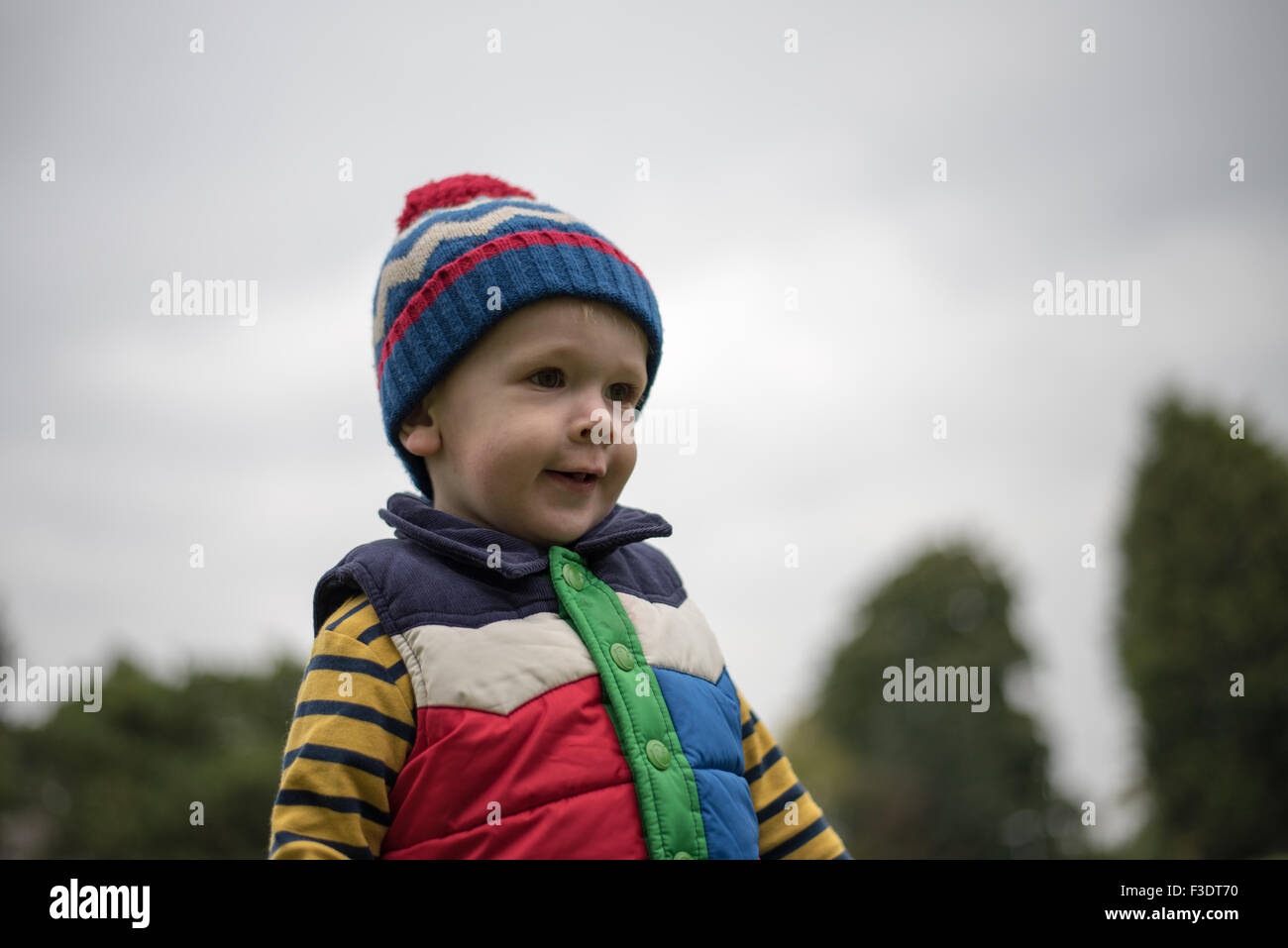 Cheeky boy smiling in Park Stock Photo