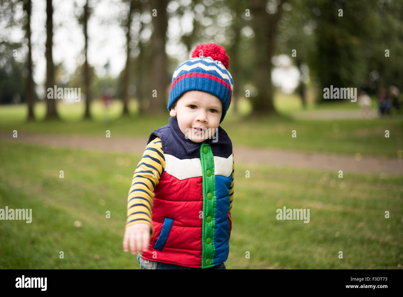Boy with Cheeky face in park Stock Photo