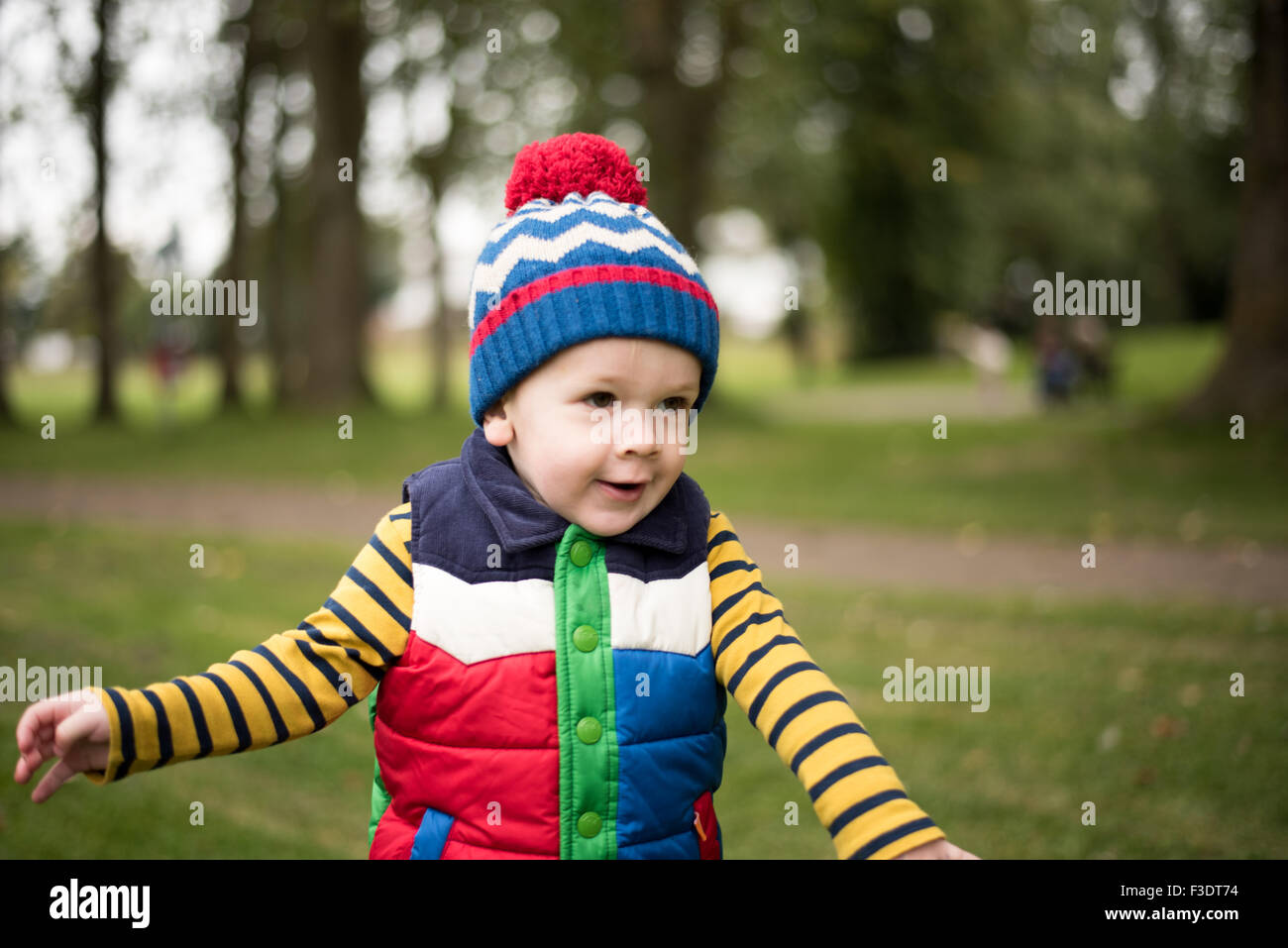 Boy running in park Stock Photo