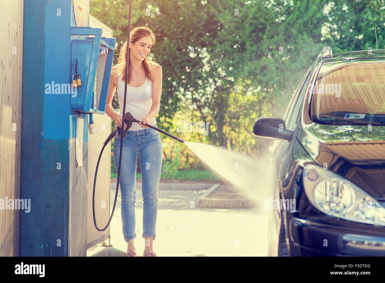 Pretty woman in the car wash - hand wash Stock Photo