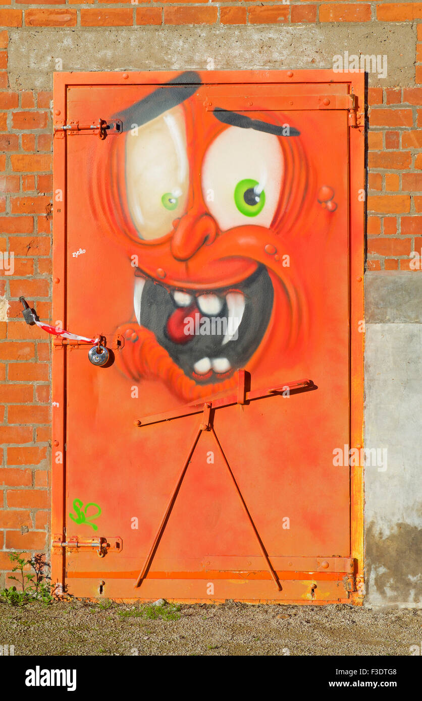 Door embellished with cartoon grafitti graffiti of face, England UK Stock Photo