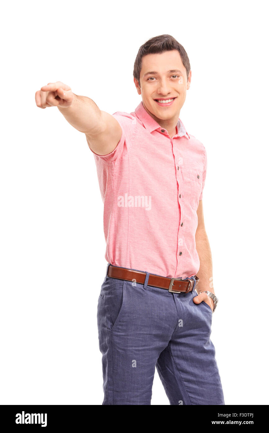 Vertical shot of a confident young man pointing forward with his hand and looking at the camera isolated on white background Stock Photo