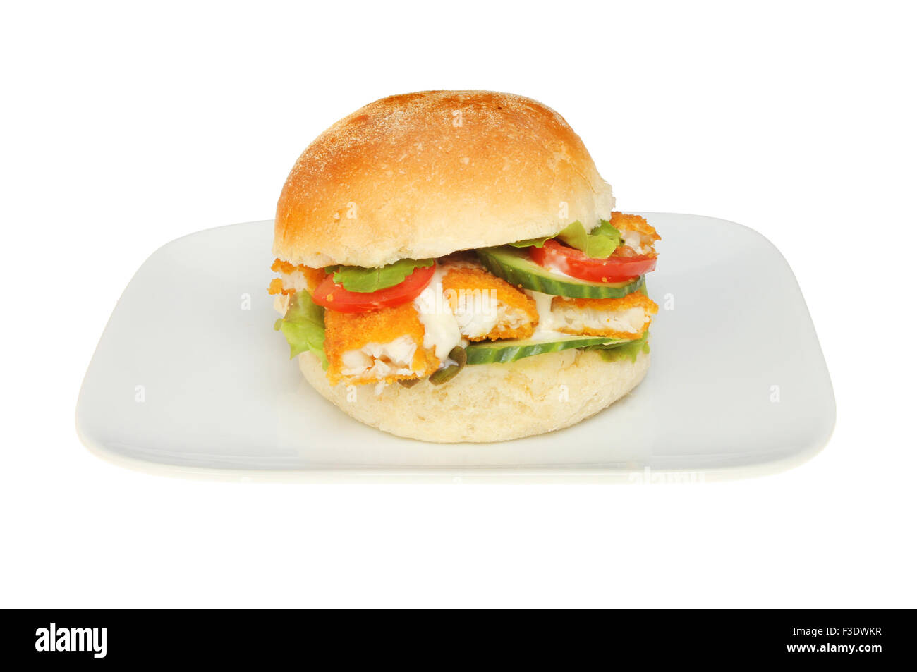 Fish fingers with salad and tartar sauce in a soft bread roll on a plate isolated against white Stock Photo