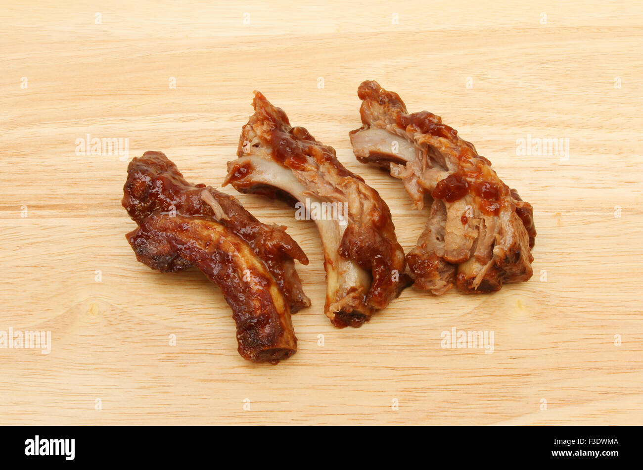 Pork spare ribs cooked in barbecue sauce on a wooden board Stock Photo