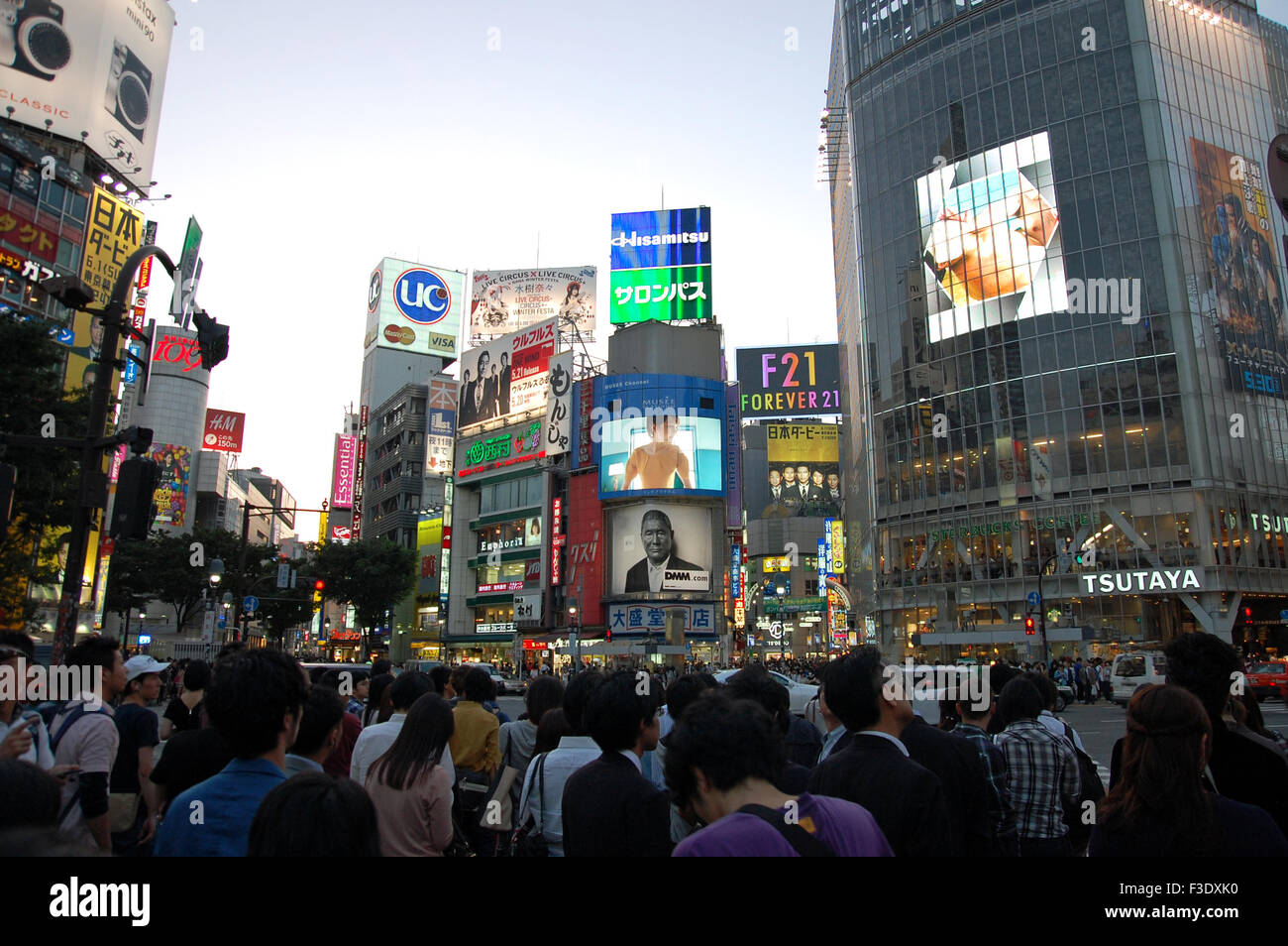 People waiting before the video screens and Tsutaya building to cross The Scramble intersection in Shibuya, Japan. Stock Photo
