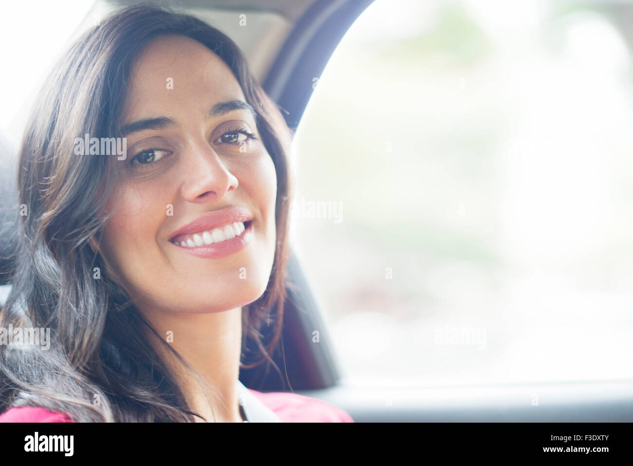 Woman smiling in car, portrait Stock Photo