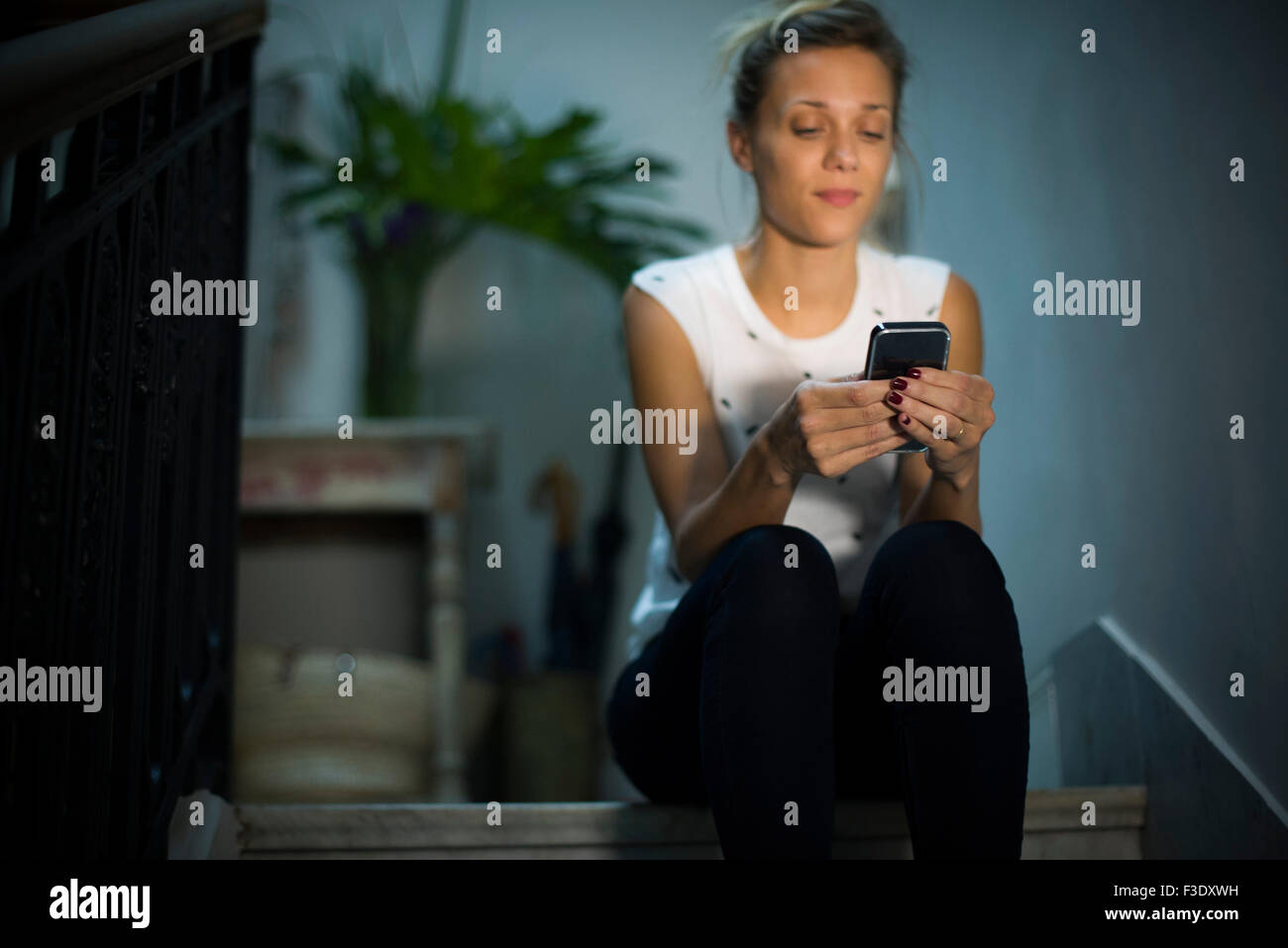 Woman text messaging with smartphone Stock Photo
