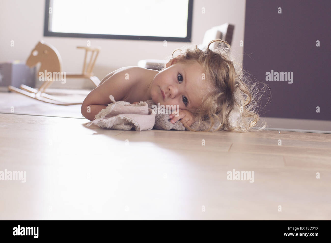 Baby girl lying on floor, portrait Stock Photo
