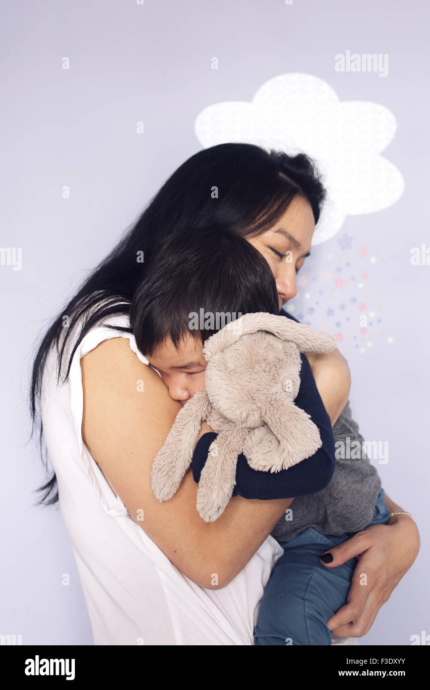 Mother embracing young son Stock Photo