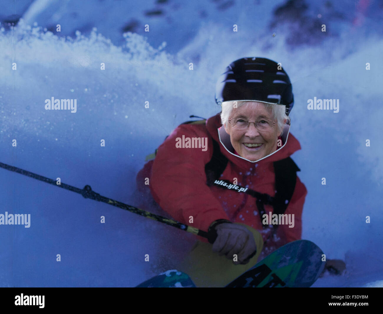 Elderly woman with head through cut out of a skier Czarna Gora ski resort Black Mountain Poland Stock Photo