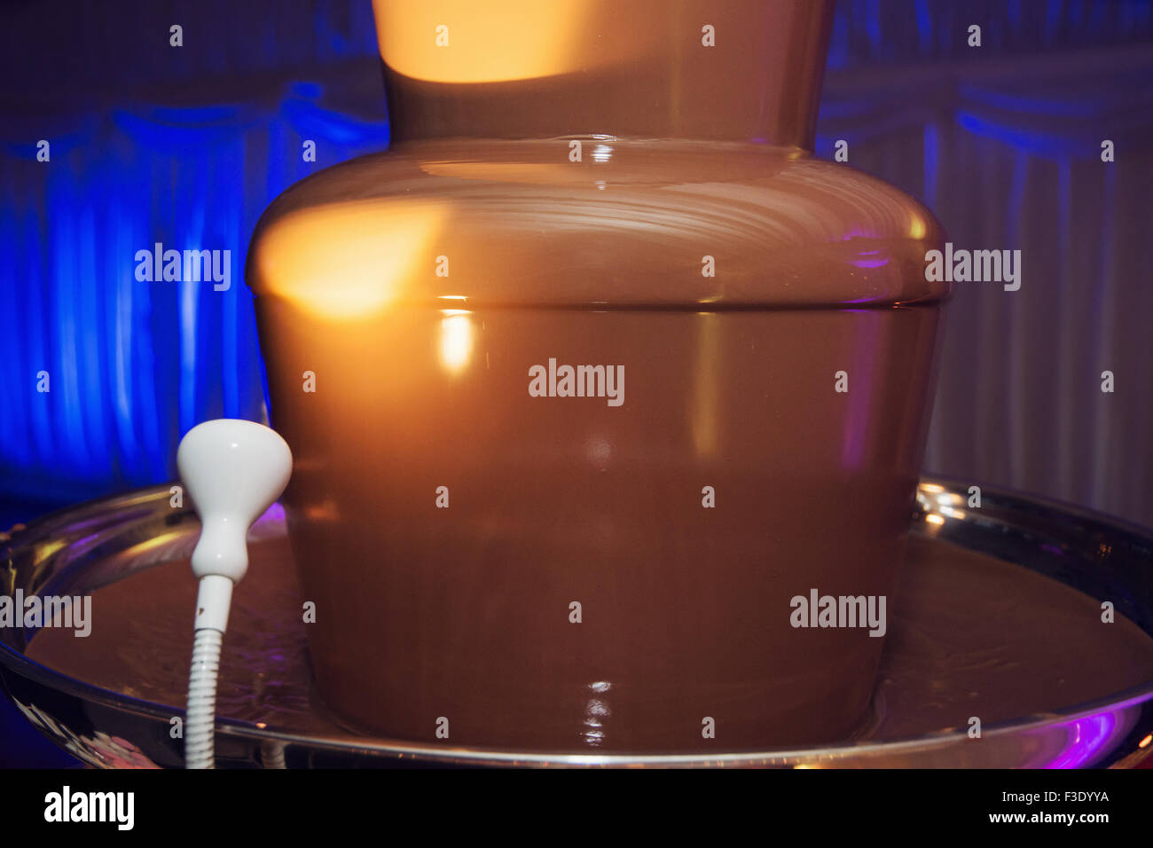 Picture of wedding fountain with sweet liquid chocolate. Taste sweet