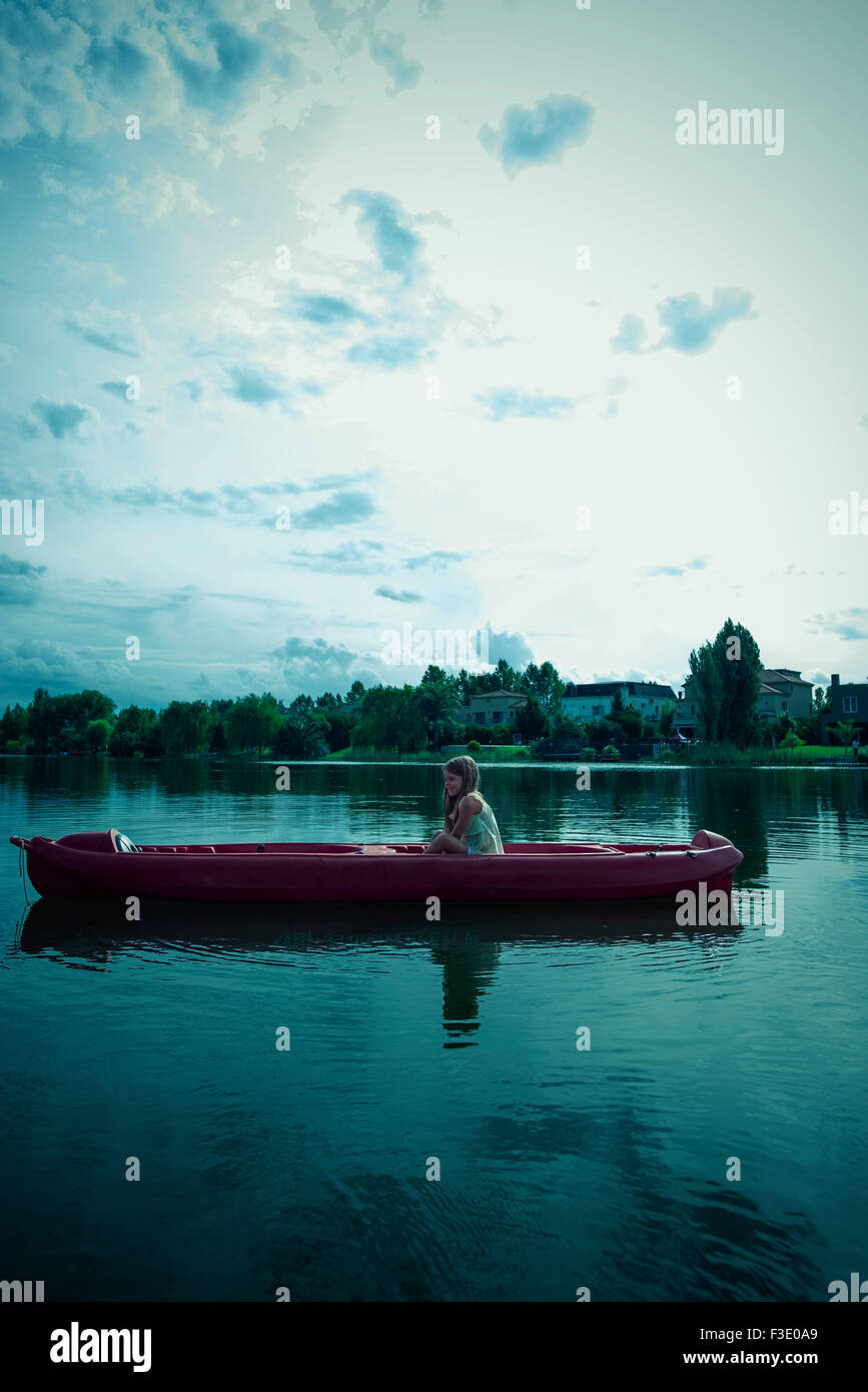 Girl kayaking on lake Stock Photo