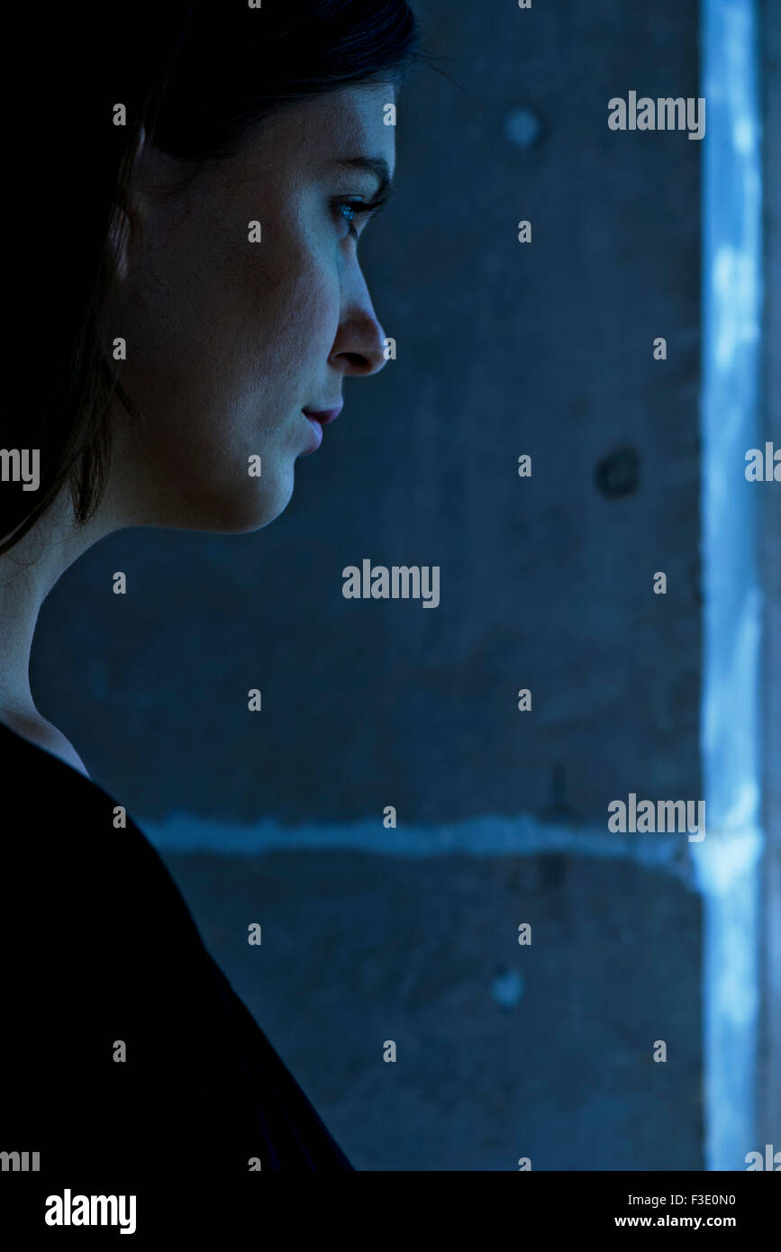 Young woman in thought, side view, portrait Stock Photo