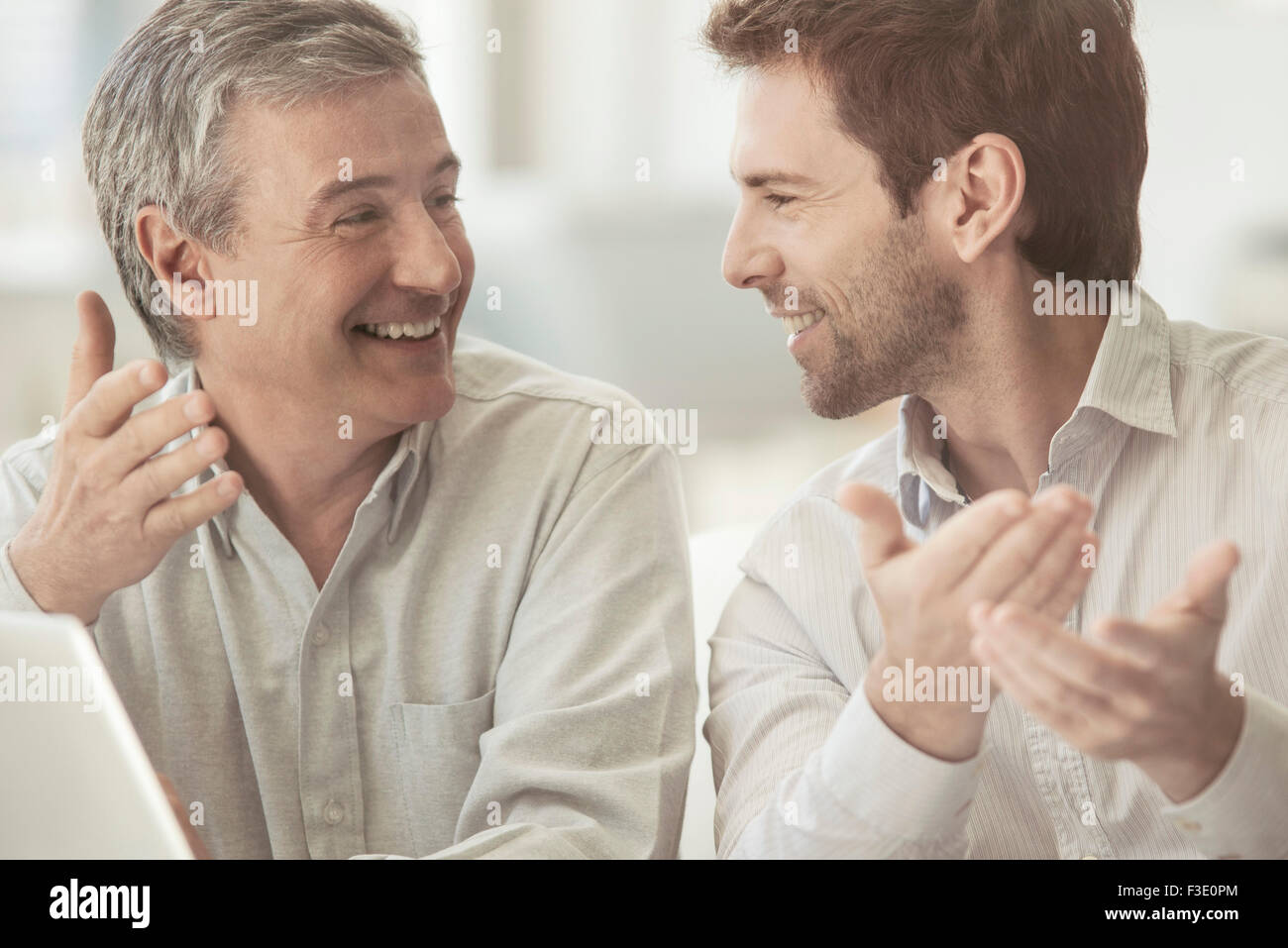 Colleagues talking and smiling together Stock Photo