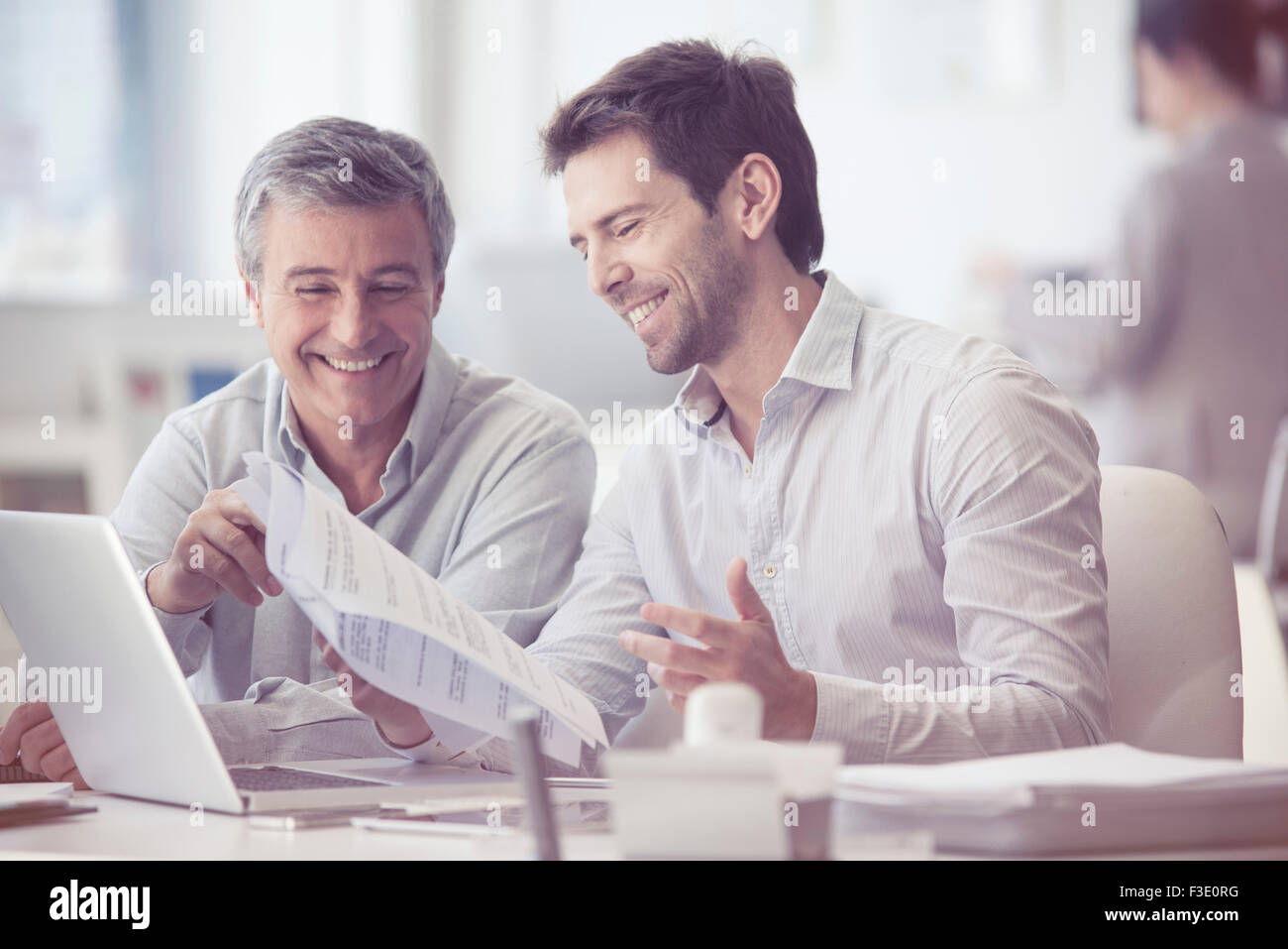 Colleagues discussing work in office Stock Photo