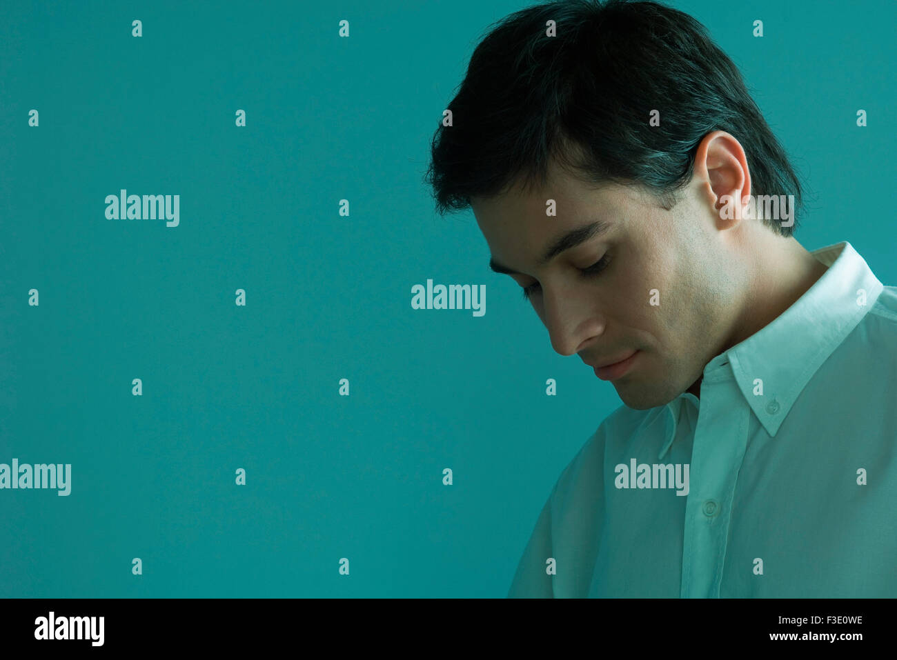 Man with head down, looking down in thought Stock Photo Alamy