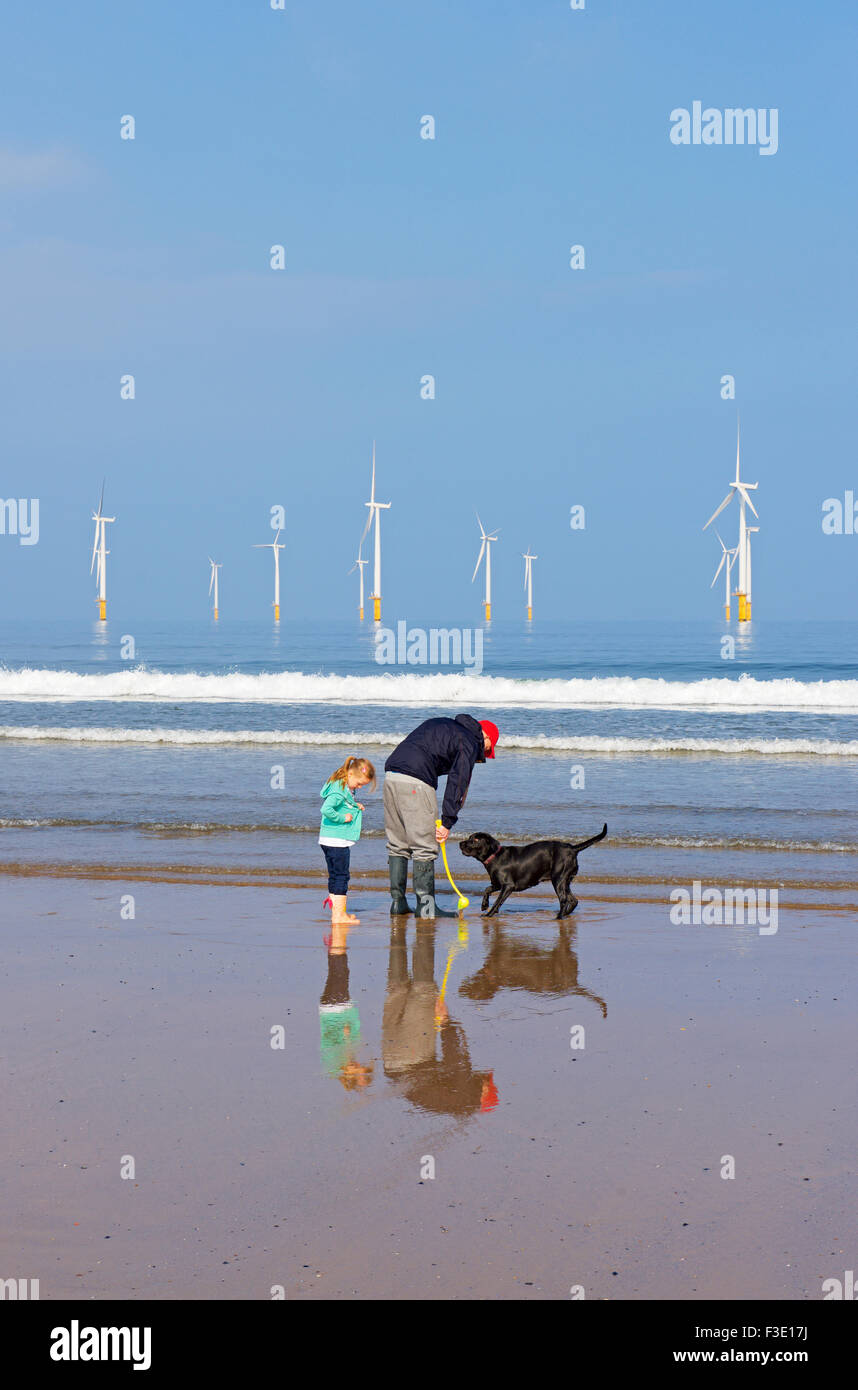 Man, young girl and dog on the beach at Redcar, Cleveland, England UK Stock Photo