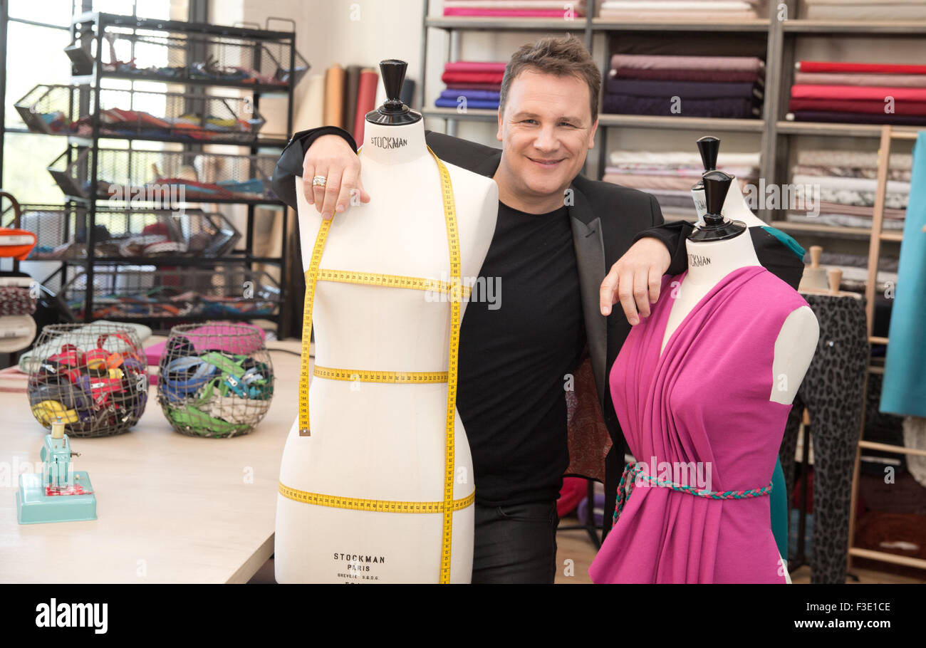 Fashion designer Guido Maria Kretschmer poses between two dress forms during filming for the VOX channel sewing competition 'Geschickt eingefaedelt - Wer naeht am besten?' (lit. Skilfully threaded - who sews the best?) in Berlin, Germany, 23 April 2015. Photo: JOERG CARSTENSEN/dpa Stock Photo