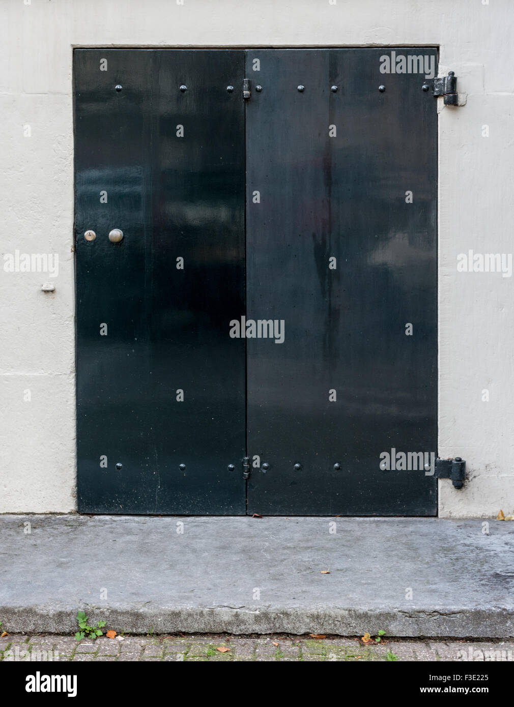 A black folding house door on a white house in Amsterdam, The Netherlands. Stock Photo