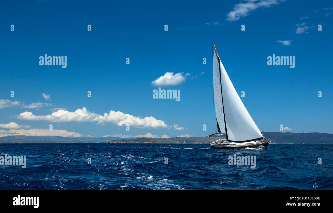 Ship yachts with white sails in the open Sea. Sailing luxury boats. Stock Photo